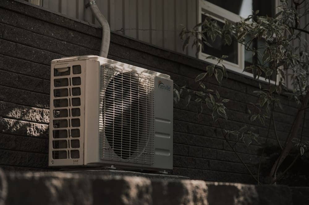 Wall-mounted mini-split condenser installed on brick