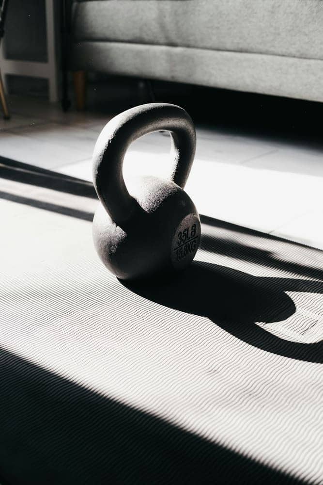 Kettlebell resting on a mat in morning light